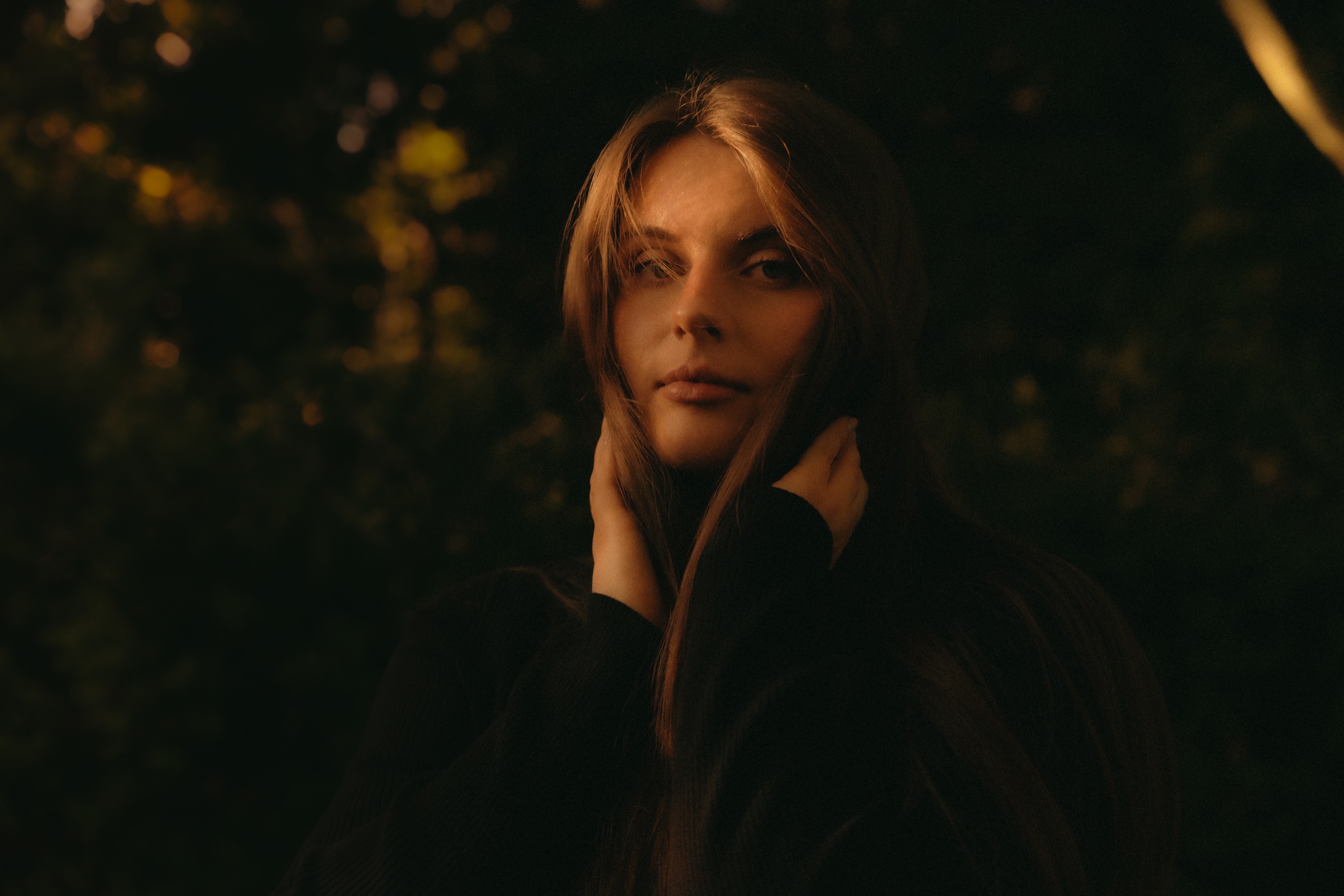 Moody portrait in deep green and amber evening light