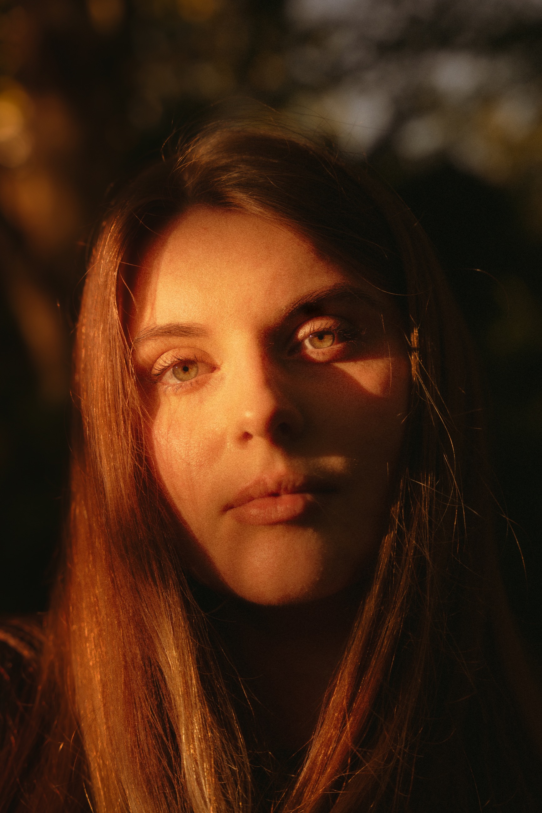 Close portrait shaped by warm evening light and shadow