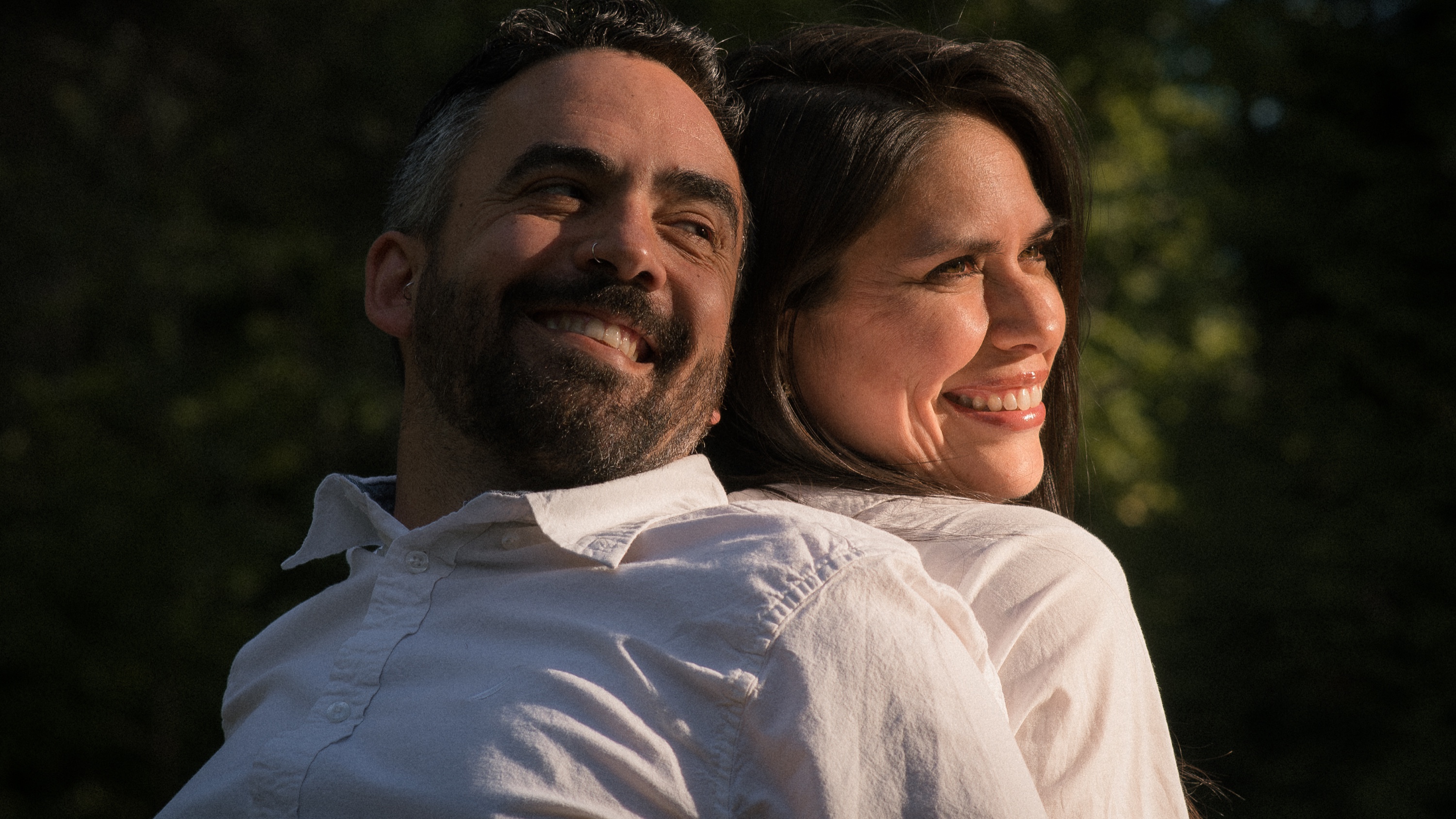 A couple smiling together in warm evening light