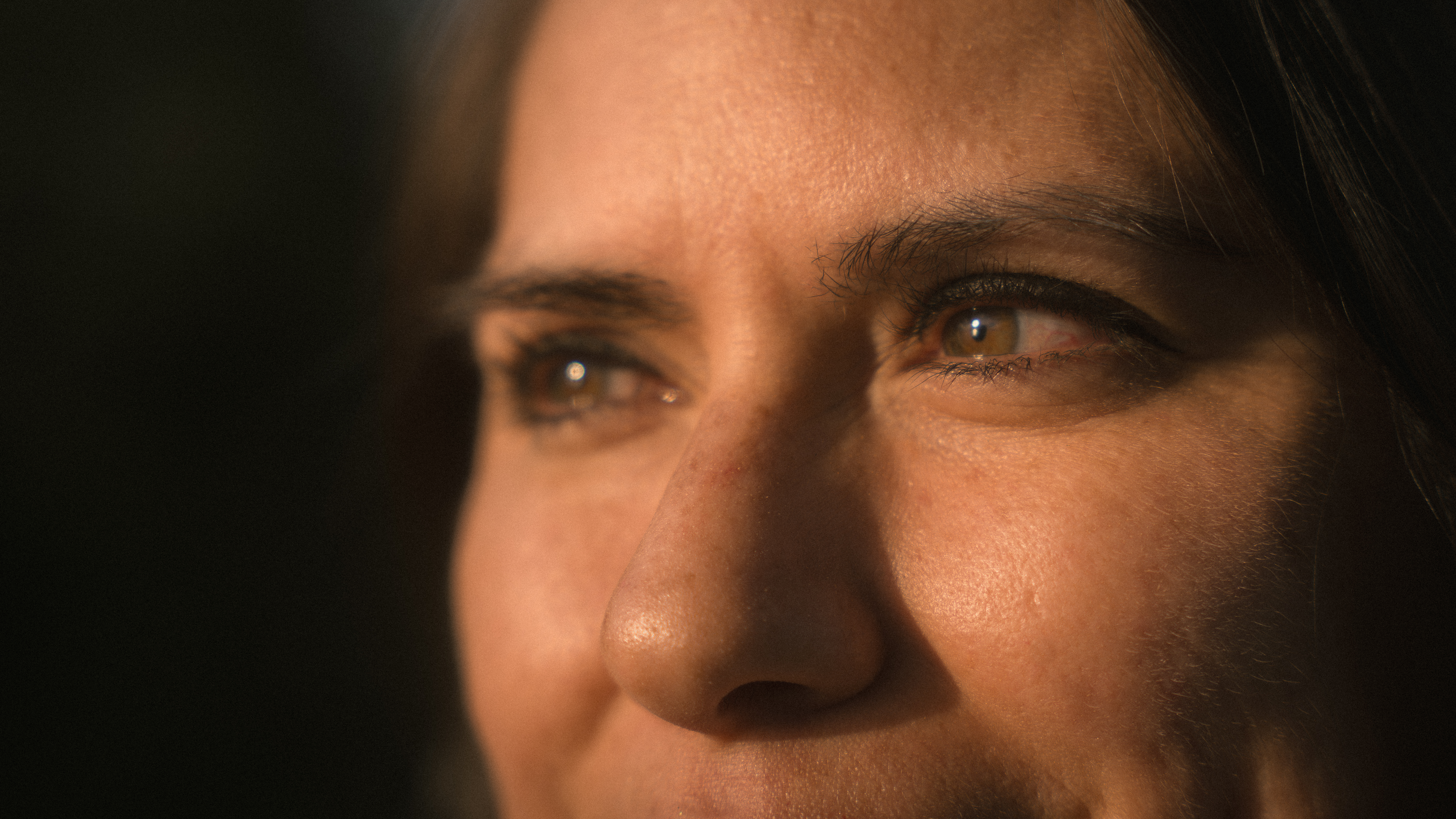 Close portrait of a woman looking toward her partner