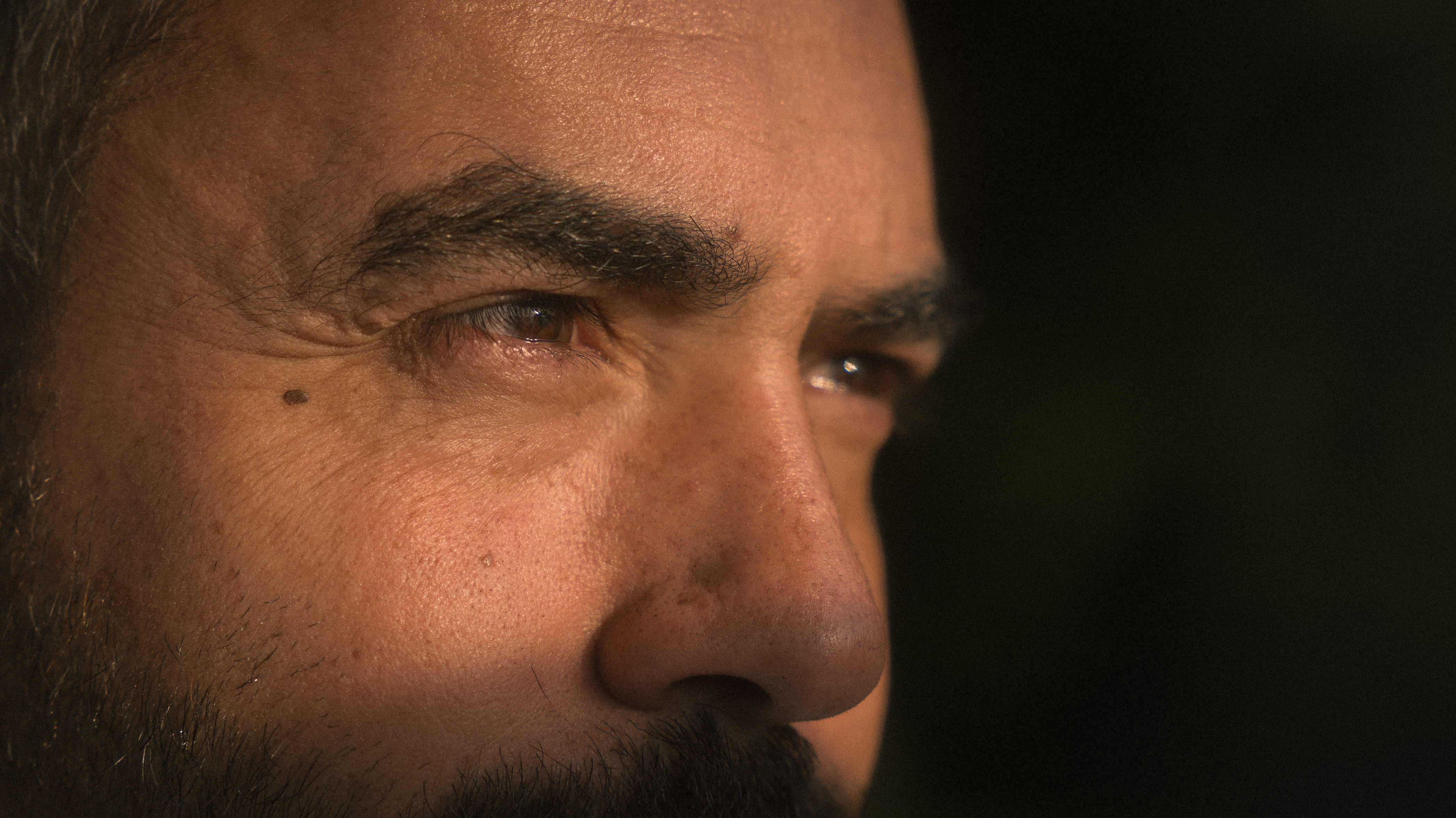 Close portrait of a man looking toward his partner