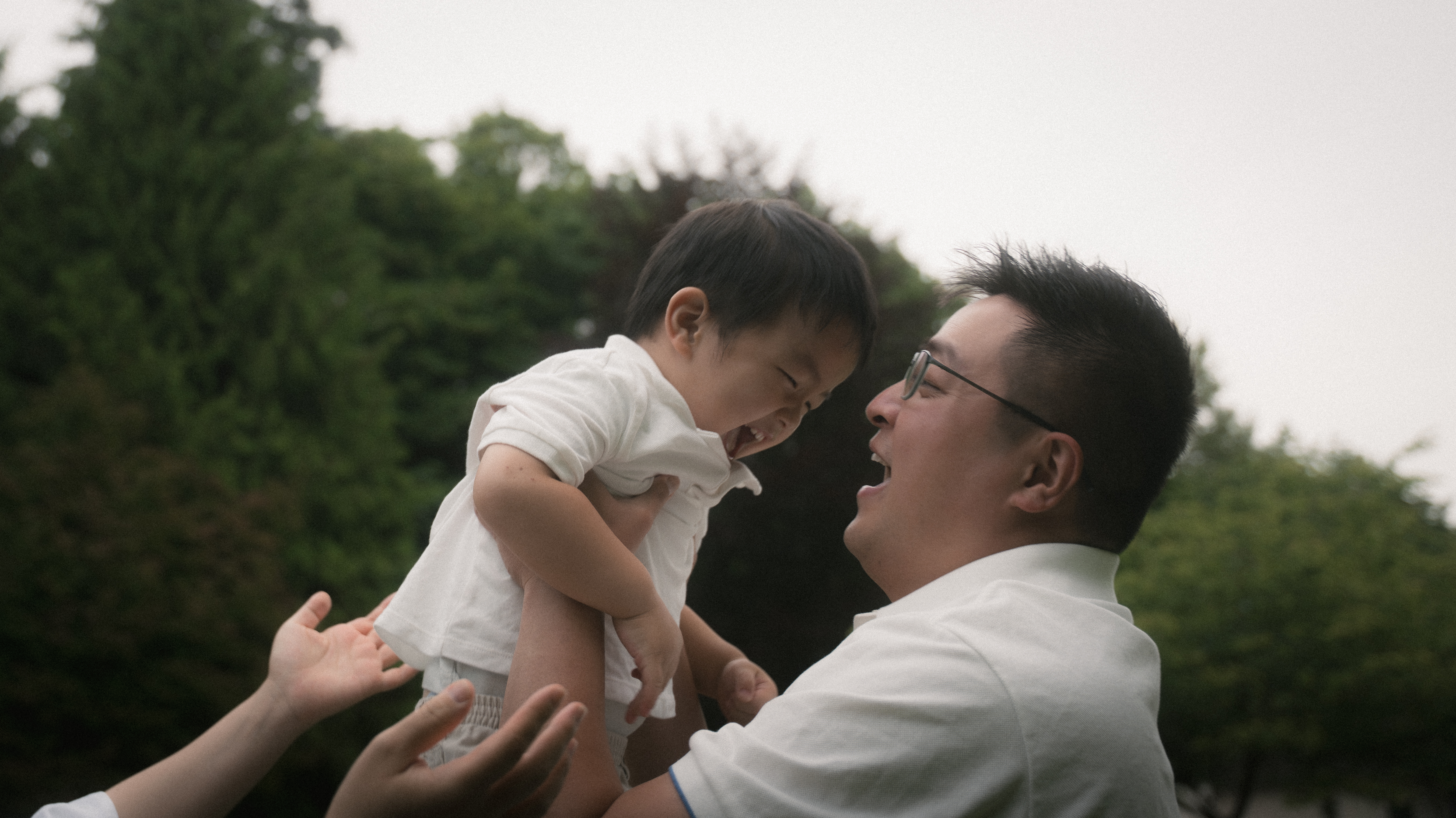A father and young child laughing together