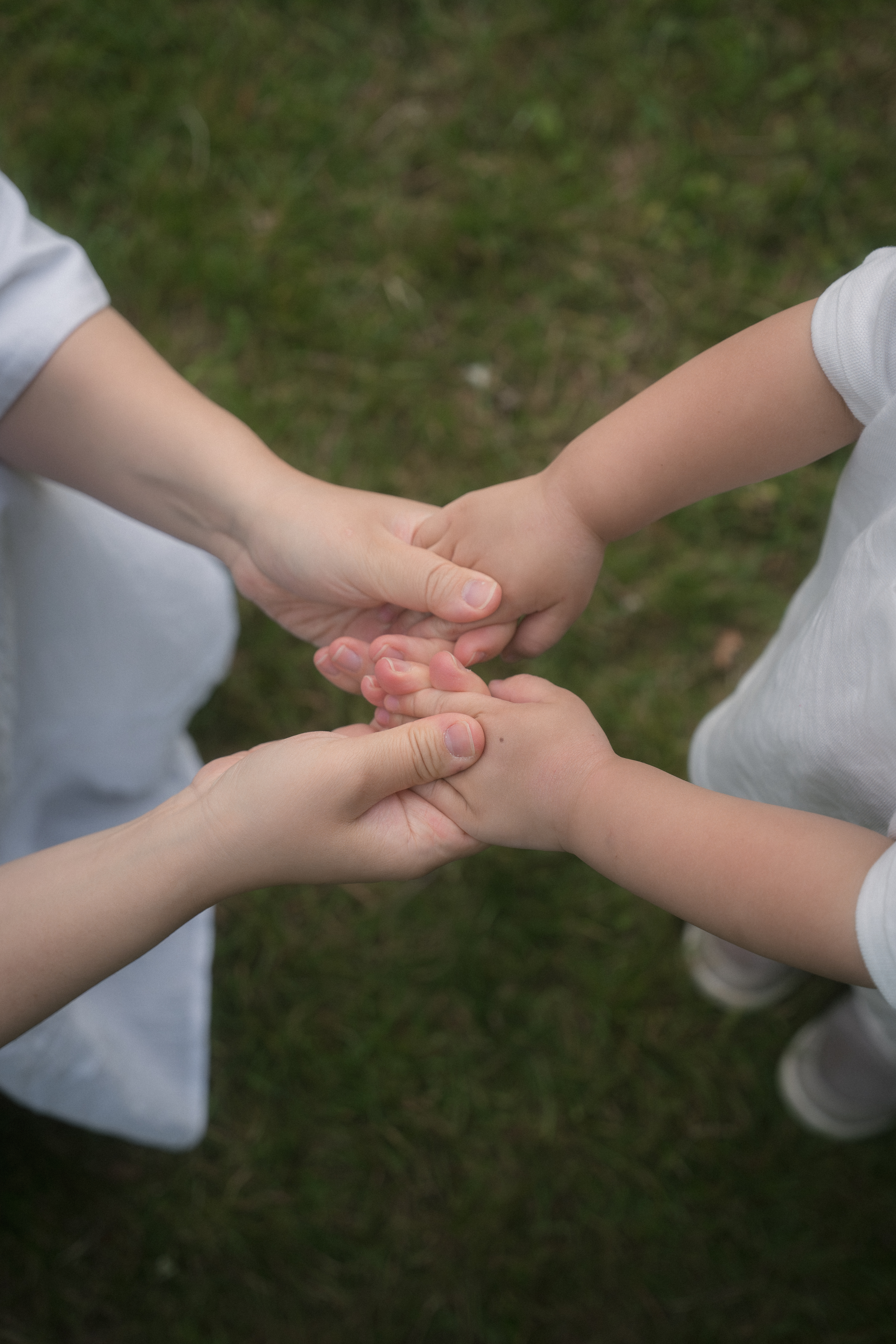 A close detail of a family holding hands